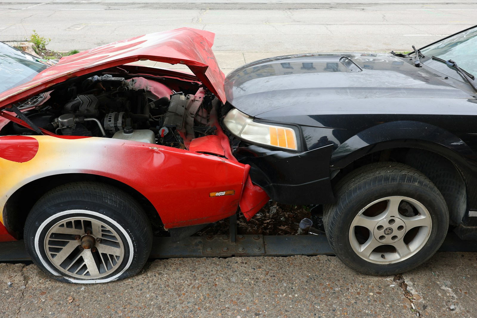 Cars are involved in a frontal collision.